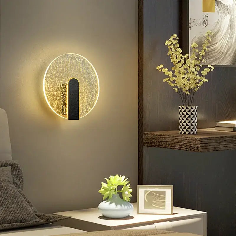 Modern black and gold crackled glass led wall lamp with glowing golden rim and black accent for bedroom lighting