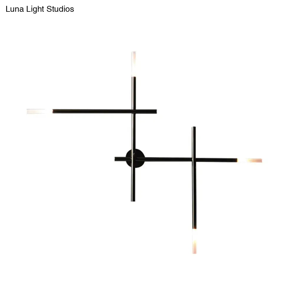 Modern black and gold wall light with crossed lines and frosted glass light fixture for bedroom illumination
