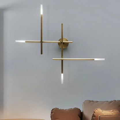 Modern black and gold brass wall light with crossed lines and slim led light strips for bedroom lighting fixture