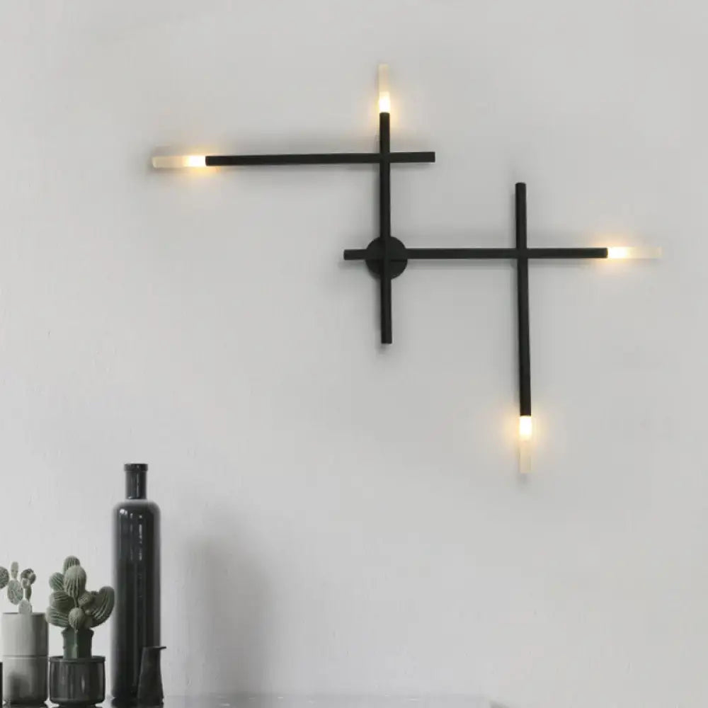 Modern black and gold wall light with crossed lines geometric arms and warm led light fixture for bedroom use