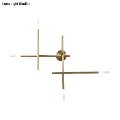 Modern black and gold brass wall light with minimalist crossed lines and four slender arms central circular base light fixture