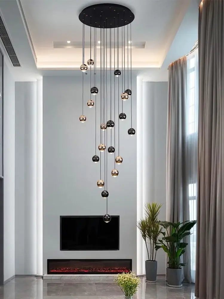 A modern black and gold crystal ball pendant light with spherical design and circular ceiling mount for living room decorbites