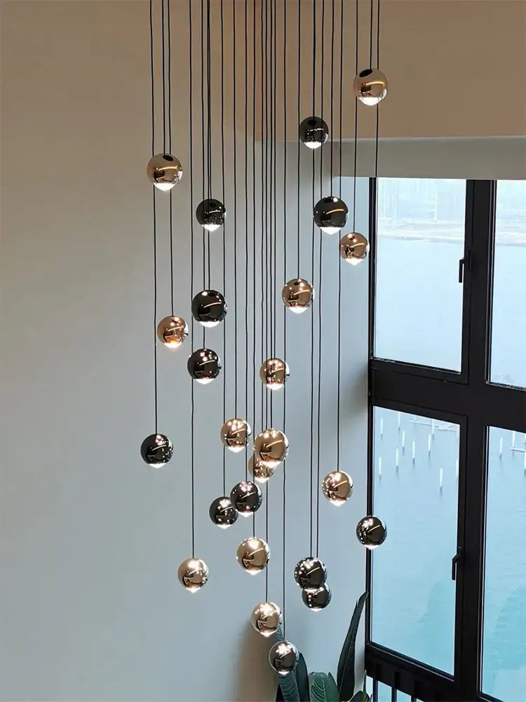 A modern black and gold crystal ball pendant light with polished spherical bulbs for living room decorbites pendant light