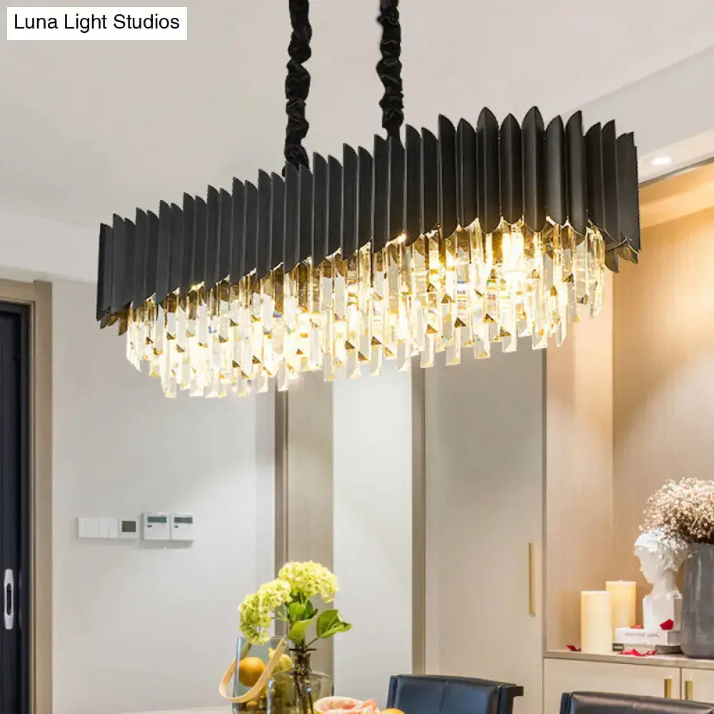 Modern black and gold rectangular chandelier featuring cascading clear crystal prisms for dining room lighting