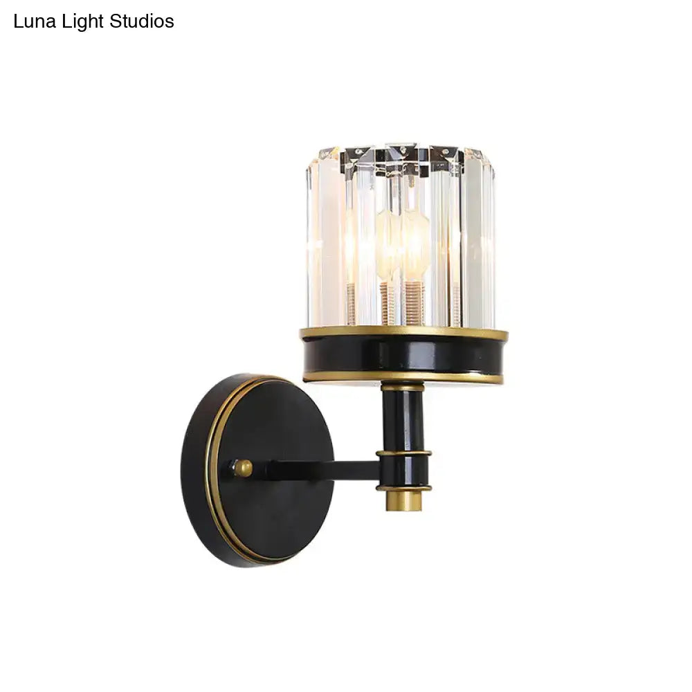 Modern black and gold wall light with a crystal cylinder glass shade perfect for hallway lighting