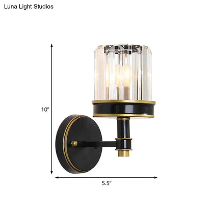 Modern black and gold wall light with a crystal cylinder wall shade suitable for hallway lighting
