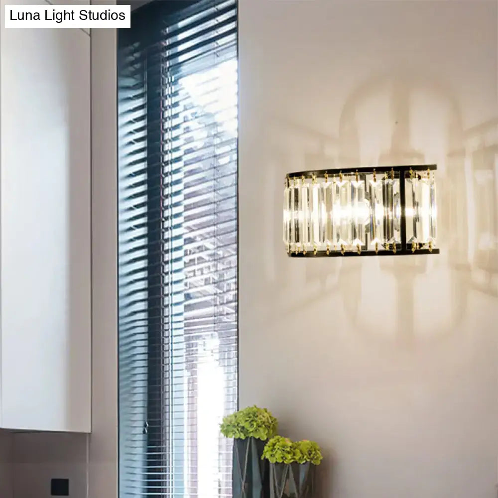 Modern black and gold crystal half cylinder wall sconce with clear crystal half rods in a black metal frame for bedroom light