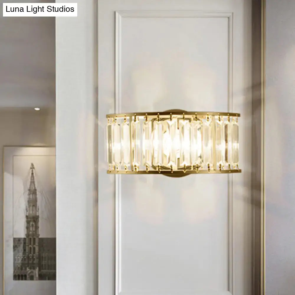 Modern black and gold crystal half cylinder wall sconce with gold-toned rectangular frame and clear crystal half rods