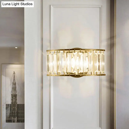 Modern black and gold crystal half cylinder wall sconce with gold-toned rectangular frame and clear crystal half rods