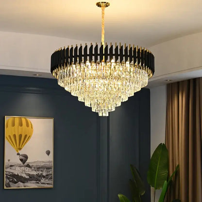 A modern black and gold decorbites crystal led pendant light with a circular frame and cascading crystal prisms for dining room decor