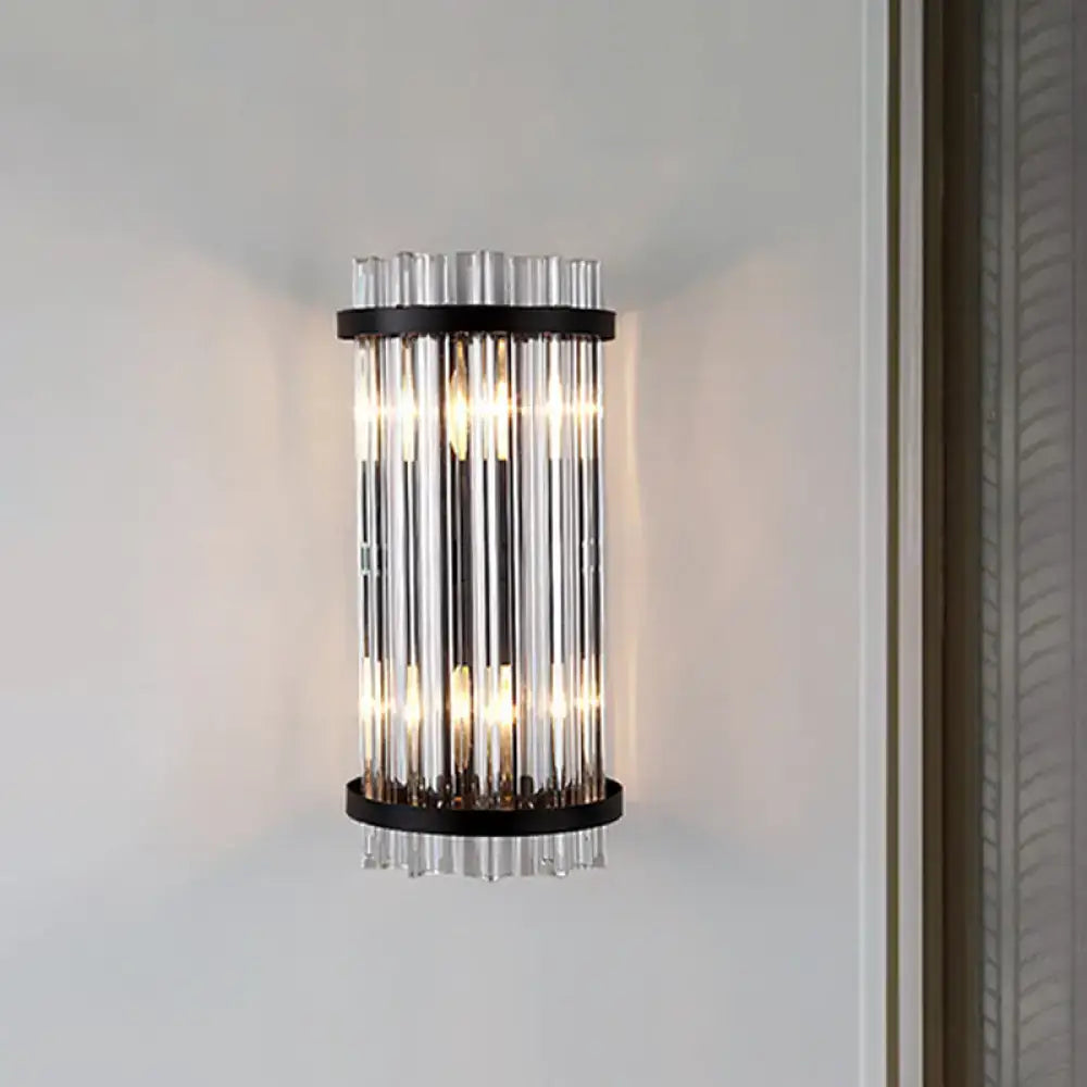 Modern black and gold crystal rod cylinder wall sconce featuring vertical clear glass tubes framed by black metal rings