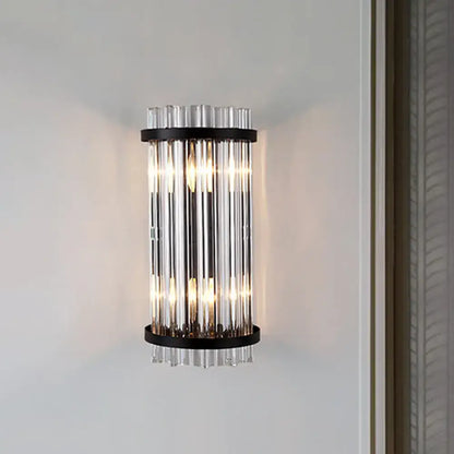 Modern black and gold crystal rod cylinder wall sconce featuring vertical clear glass tubes framed by black metal rings
