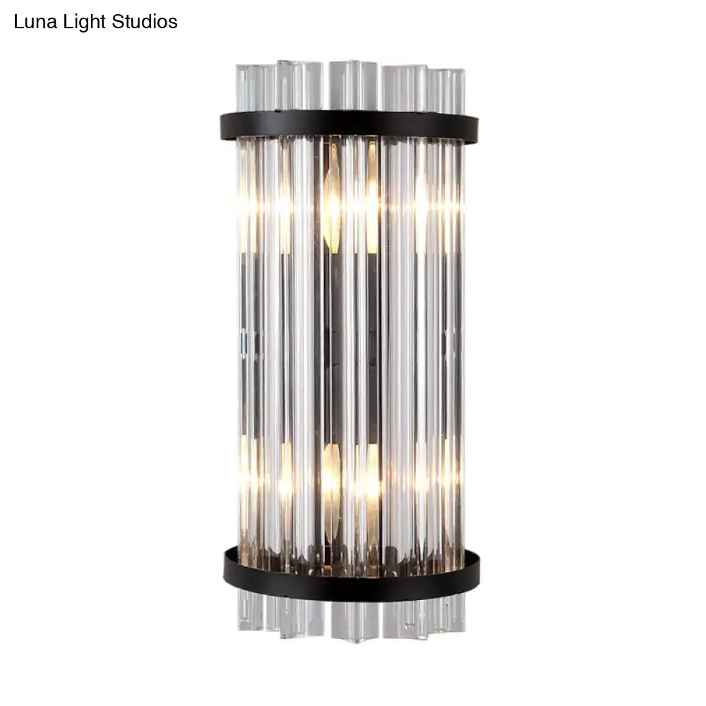 Modern black and gold crystal rod cylinder wall sconce with vertical clear glass tubes and sleek black metal bands for bedroom lighting