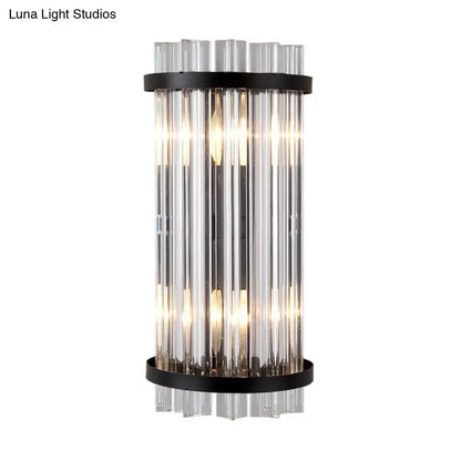 Modern black and gold crystal rod cylinder wall sconce with vertical clear glass tubes and sleek black metal bands for bedroom lighting