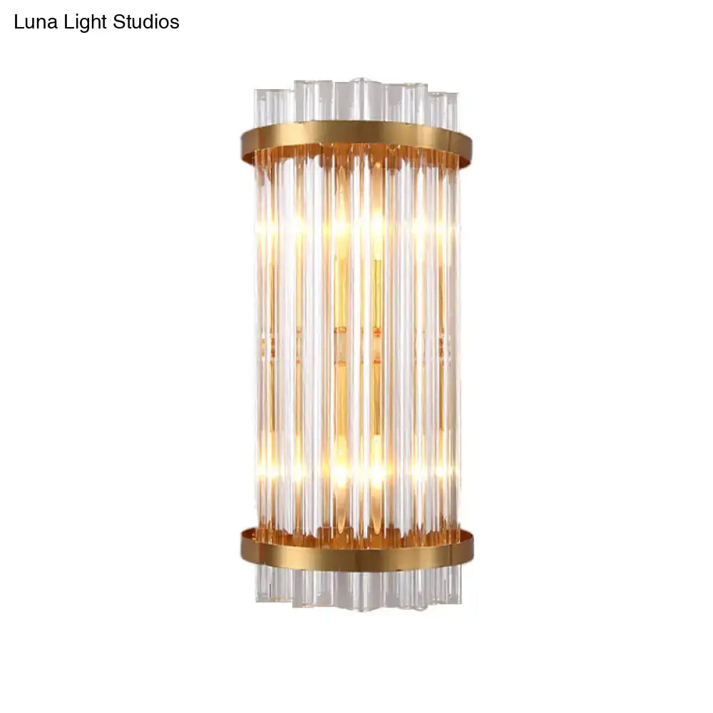Modern black and gold crystal rod cylinder wall sconce with vertical clear glass rods and polished gold metal rings