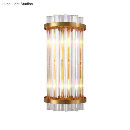 Modern black and gold crystal rod cylinder wall sconce with vertical clear glass rods and polished gold metal rings