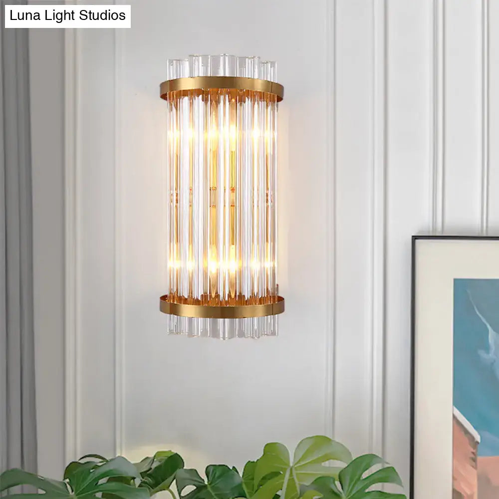 Modern black and gold crystal rod cylinder wall sconce with gold-toned vertical clear glass rods for bedroom lighting