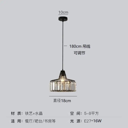 Modern black iron round pendant light with gold accents and crystal prisms, adjustable cord for dining or bar areas