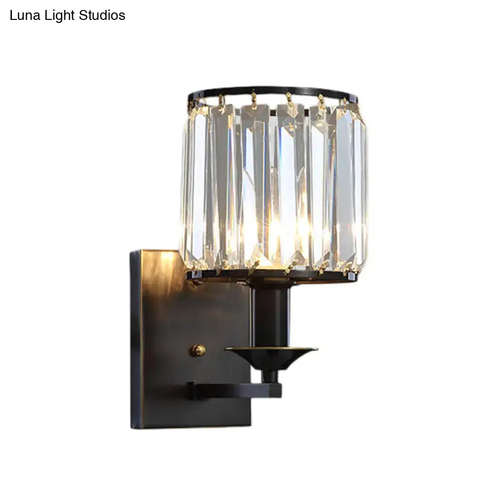 Elegant black and gold modern sconce light fixture with clear crystal prisms and direct wired electric power
