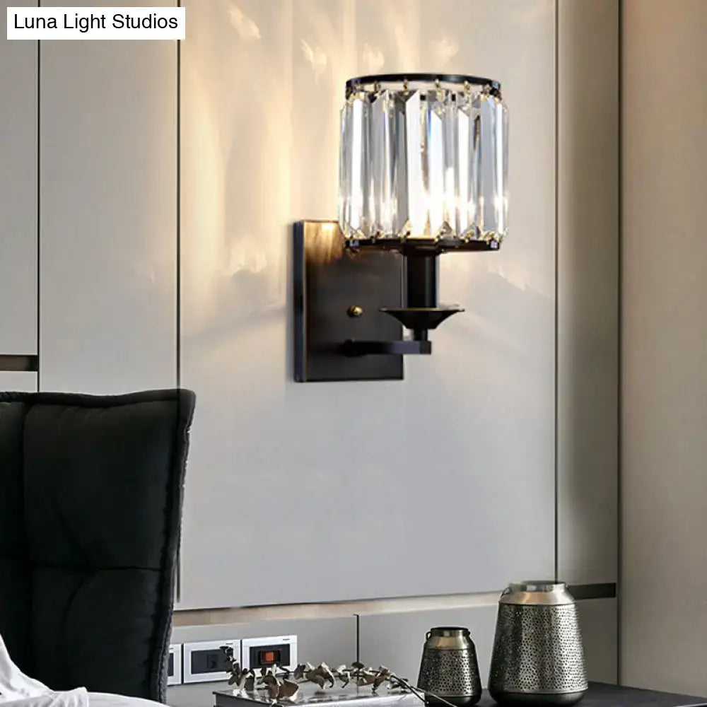 Elegant black metal sconce light fixture with vertical crystal prisms featuring modern wired electric power design