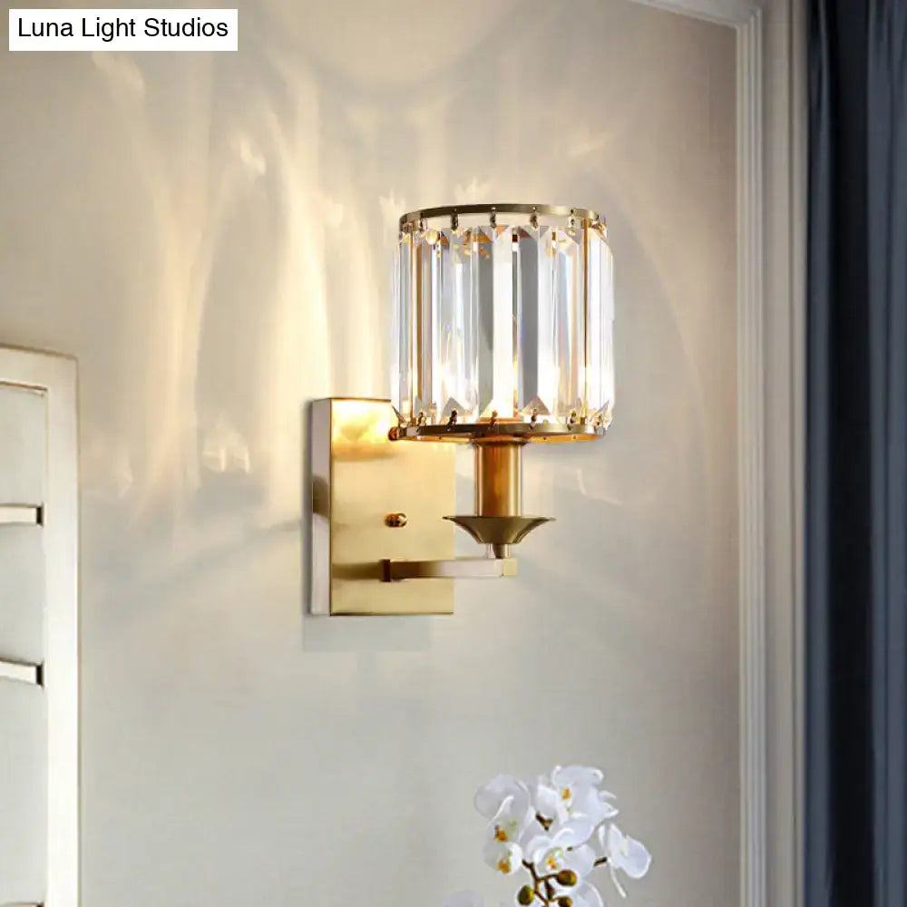 Modern black and gold sconce light fixture with cylindrical crystal shade and vertical faceted glass panels direct wired electric