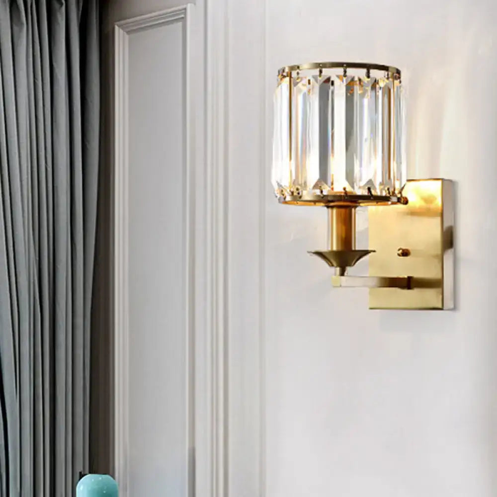 Modern black and gold sconce light fixture with gold-toned vertical crystal prisms and direct wired electric power