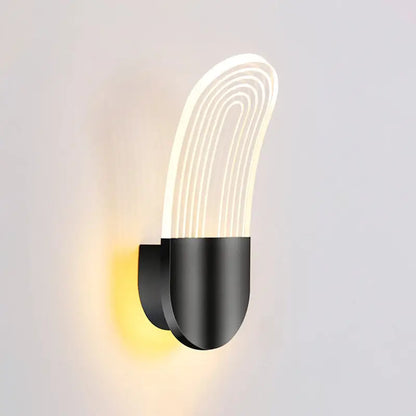Modern black and gold curved led sconce light with illuminated white acrylic diffuser and concentric light lines wall lamp