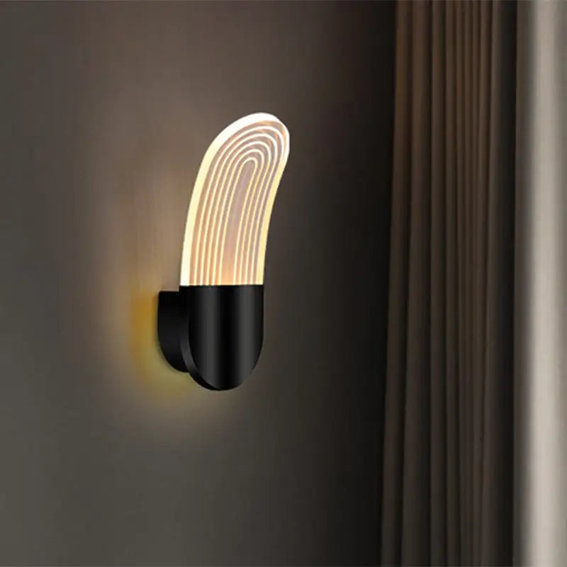 Modern black and gold curved led sconce light with illuminated translucent panel featuring concentric light lines wall lamp