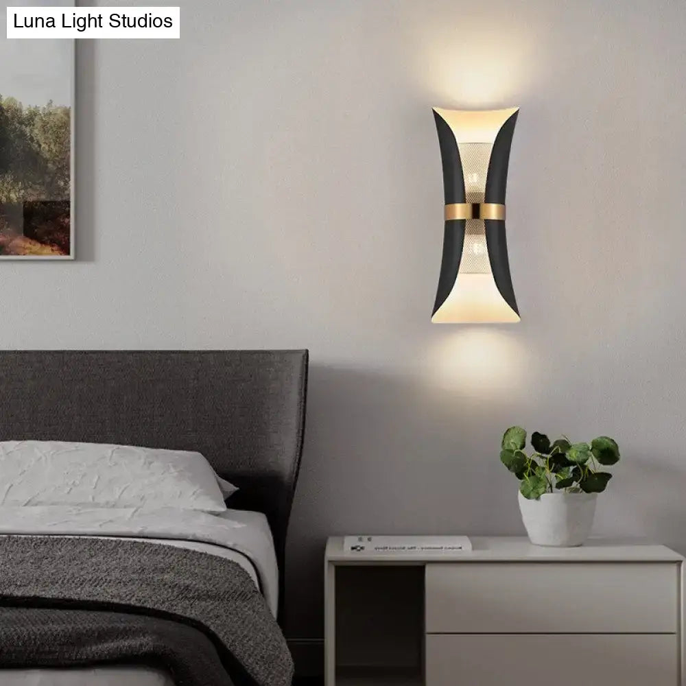 Modern black and gold curved wall lamp with sleek design ideal for bedroom lighting and decor