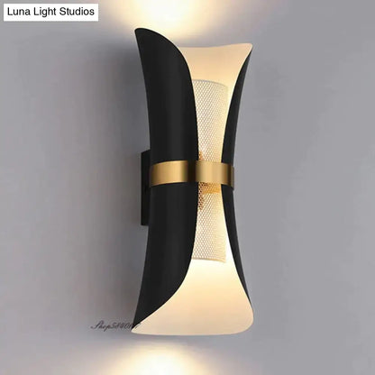 Modern black and gold curved wall lamp with frosted glass panels featuring a sculptural design for bedroom use
