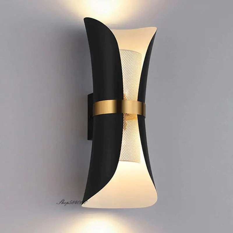 Modern black and gold curved wall lamp with frosted glass diffuser and sculptural design for bedroom lighting