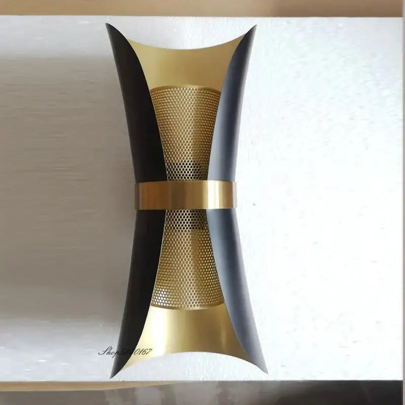Modern black and gold curved wall lamp with perforated metal panels for stylish bedroom lighting