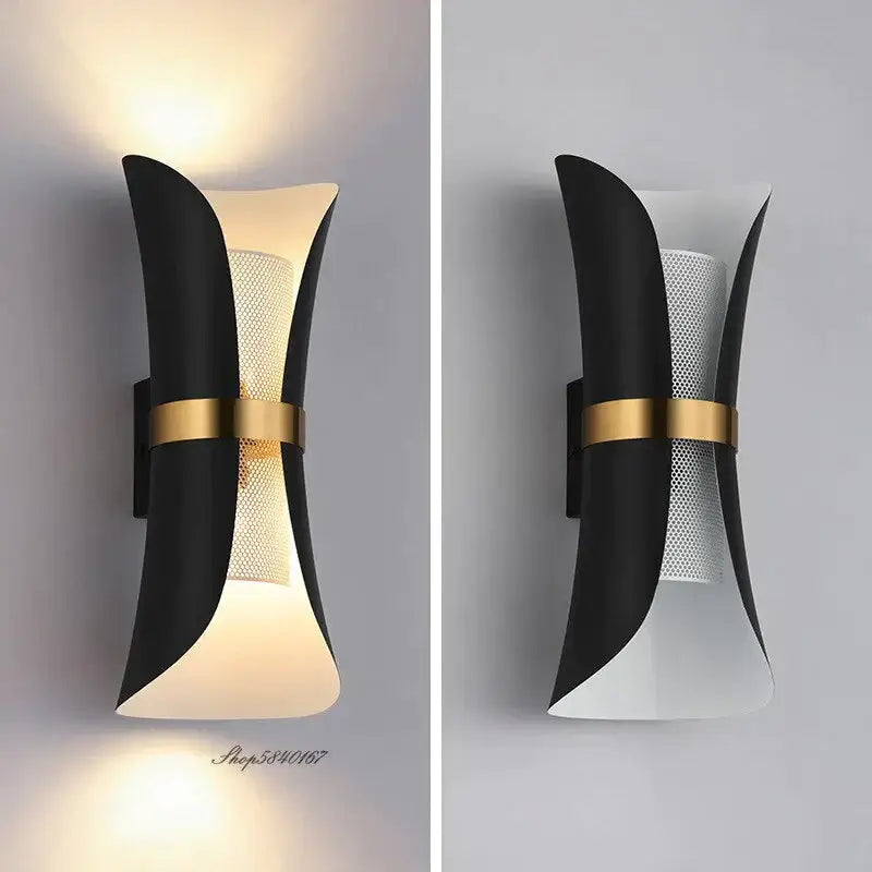 Modern black and gold curved wall lamp featuring a sculptural design with perforated mesh panel for bedroom use