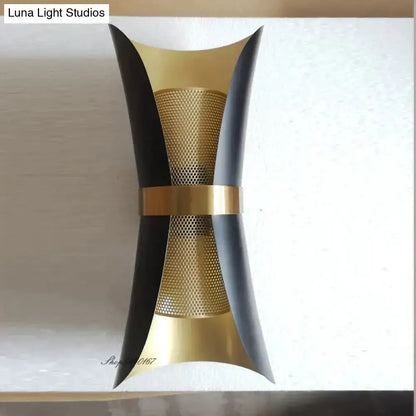 Modern black and gold curved wall lamp with sleek metal finishes and perforated mesh center for bedroom lighting