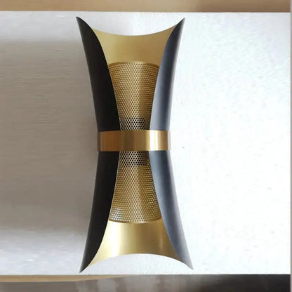 Modern black and gold curved wall lamp with sleek metallic finishes designed for bedroom wall lighting