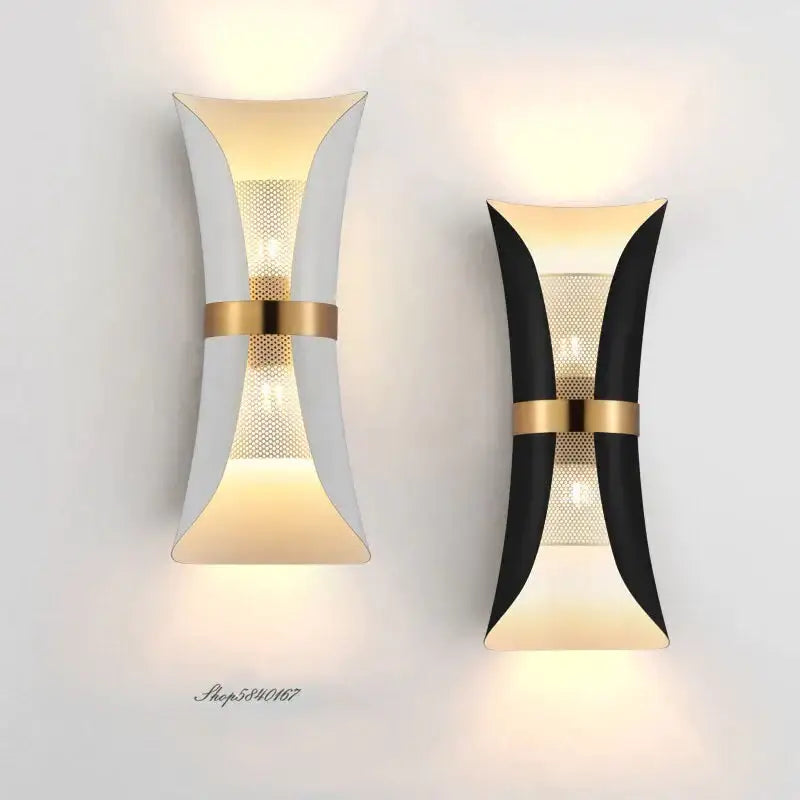 Modern black and gold curved wall lamp with sleek white and black finishes accented by gold metal bands for bedroom use