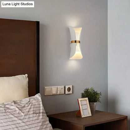 Modern white and gold wall lamp with sleek curved design ideal for bedroom lighting and decor