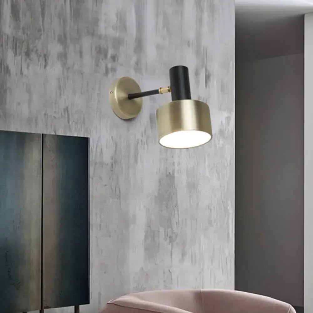 Modern black and gold cylinder sconce with adjustable arm metal wall lighting for living room use