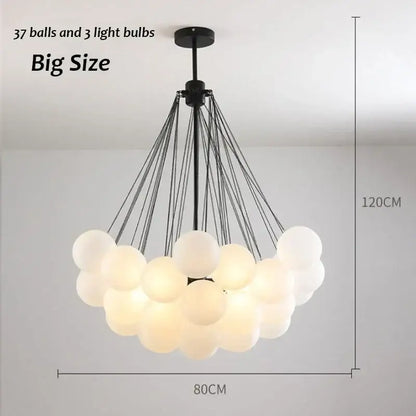 A modern black metal decorbites glass chandelier with 37 frosted orbs for dining room lighting