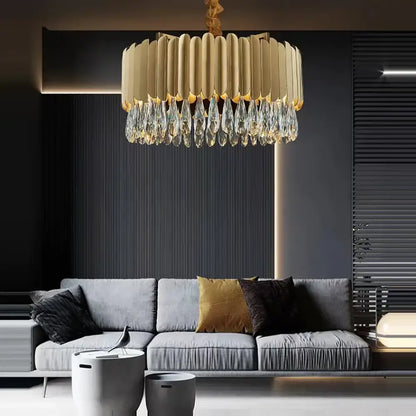 A modern gold-toned dimmable led round ceiling chandelier with ribbed design and decorbites crystal teardrop pendants