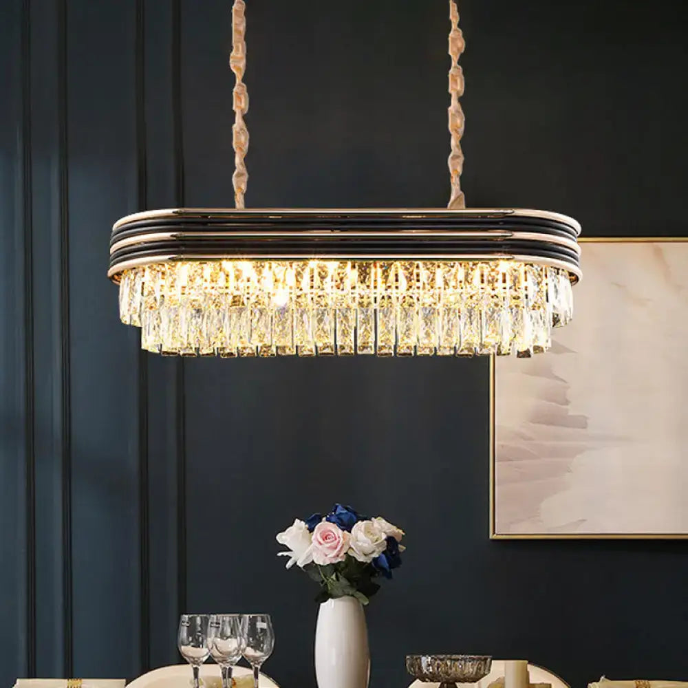 Elegant elliptical pendant lamp with chrome and black metal frame and cascading clear crystal prisms for island lighting