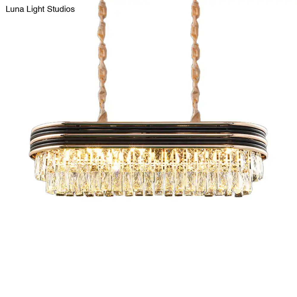 DecorBites elliptical pendant lamp in gold with black metallic bands and cascading clear crystal prisms for islands