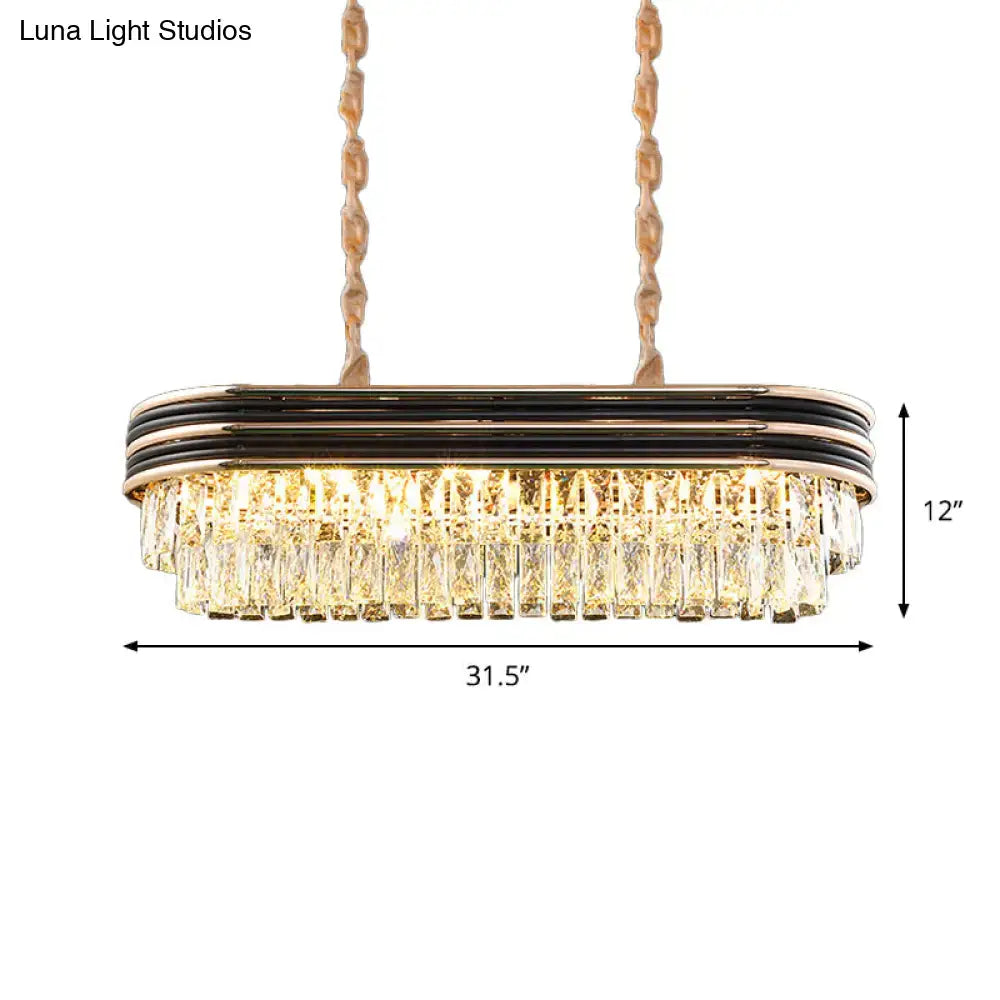 Decorbites™ elliptical pendant lamp in gold tone with black metallic bands and cascading clear crystal prisms for island lighting