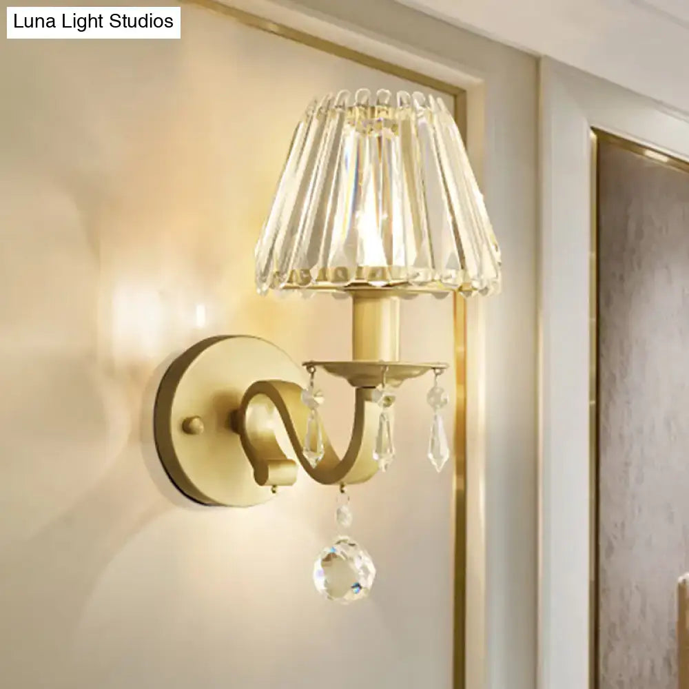 Modern black gold finish wall sconce with faceted crystal shade and dangling teardrop crystals for living room fixture height