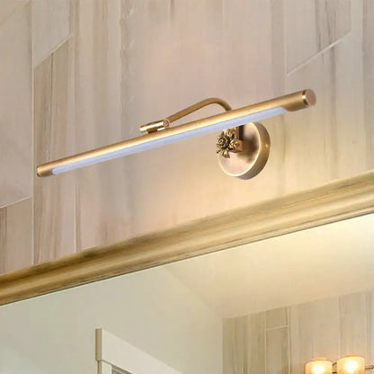 Antique brass-finished vanity wall sconce with a sleek bar design and ornate floral accent for bedroom lighting