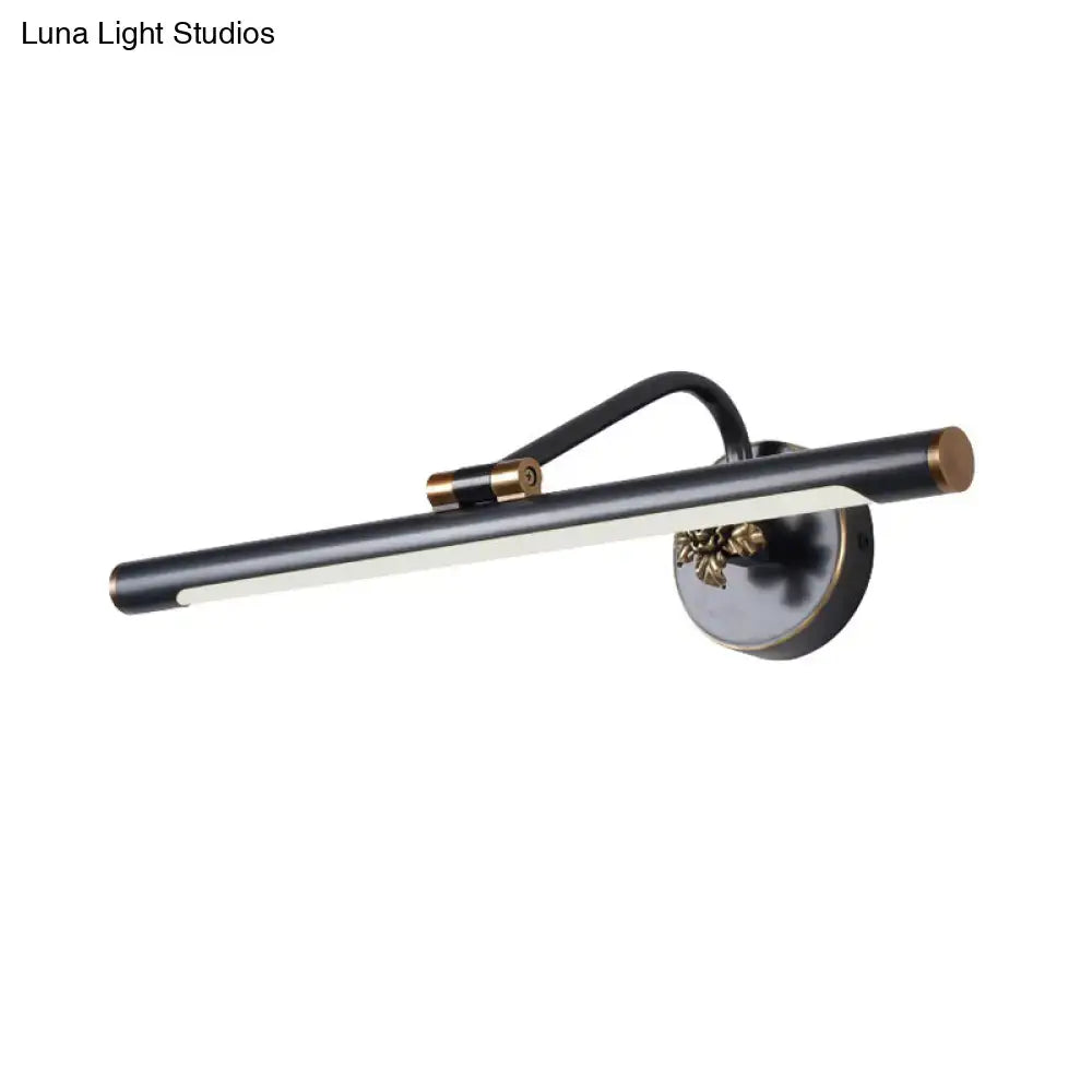 Modern black and brass vanity wall sconce with an elongated cylindrical light bar for bedroom vanity wall lighting