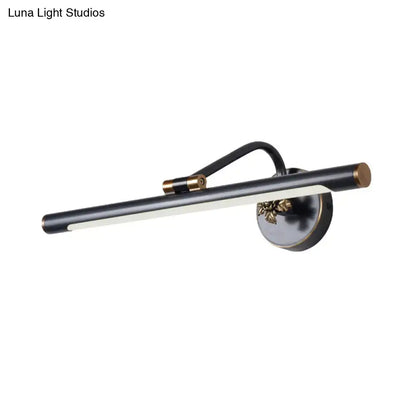 Modern black and brass vanity wall sconce with an elongated cylindrical light bar for bedroom vanity wall lighting