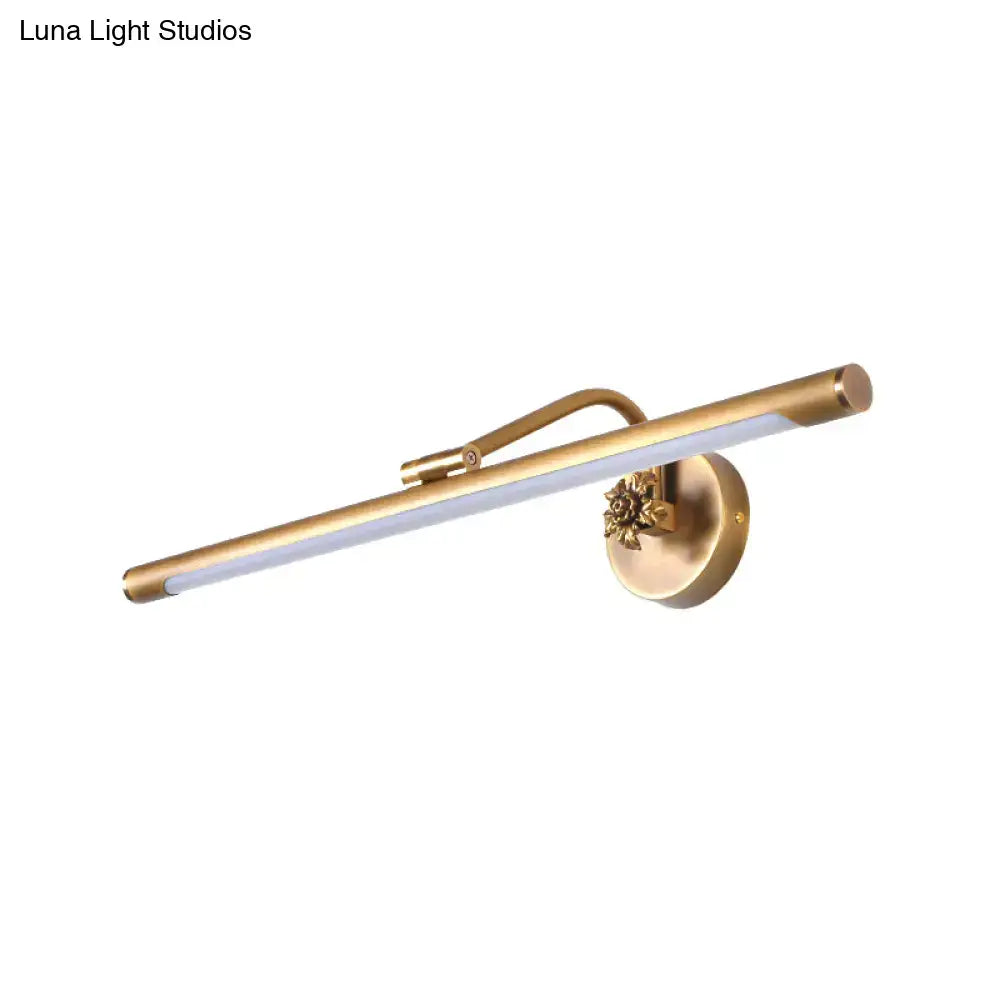 Gold-toned vanity wall sconce with sleek elongated LED bar and ornate floral base for modern bedroom lighting