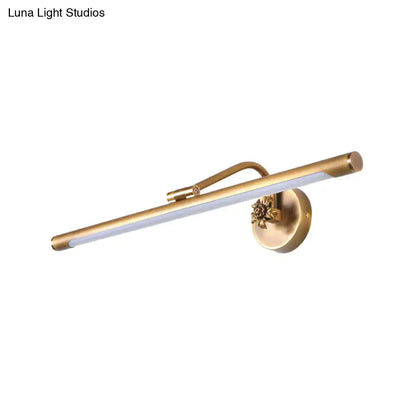 Gold-toned vanity wall sconce with sleek elongated LED bar and ornate floral base for modern bedroom lighting