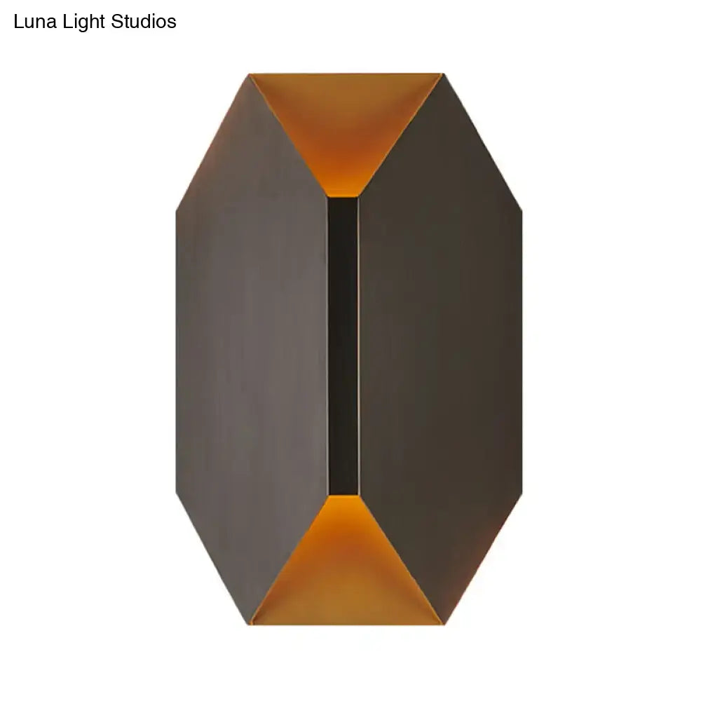 Modern black and gold geometric led wall lamp with matte black exterior and warm amber interior lighting for bedroom sconce